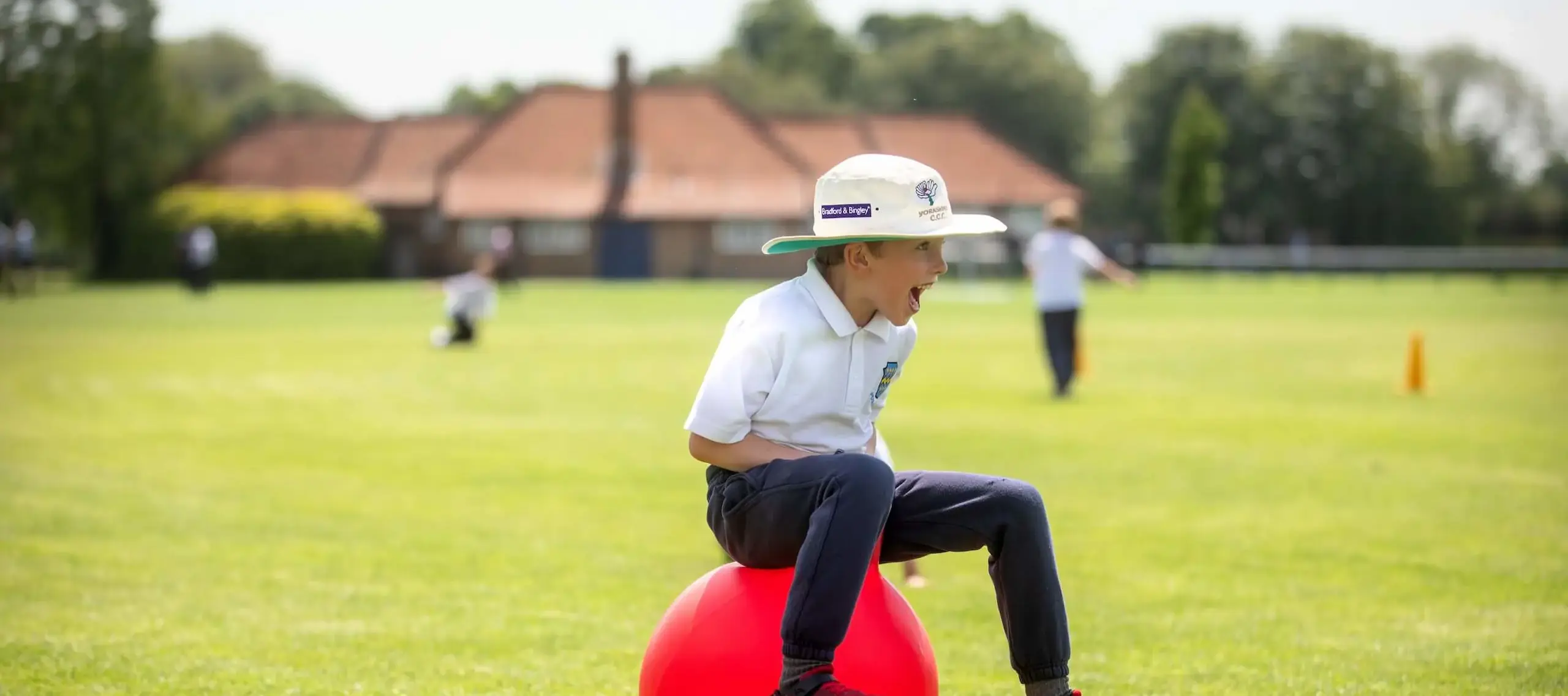 Pocklington early years pupil bouncing happily on a bouncy hopper on the School grounds