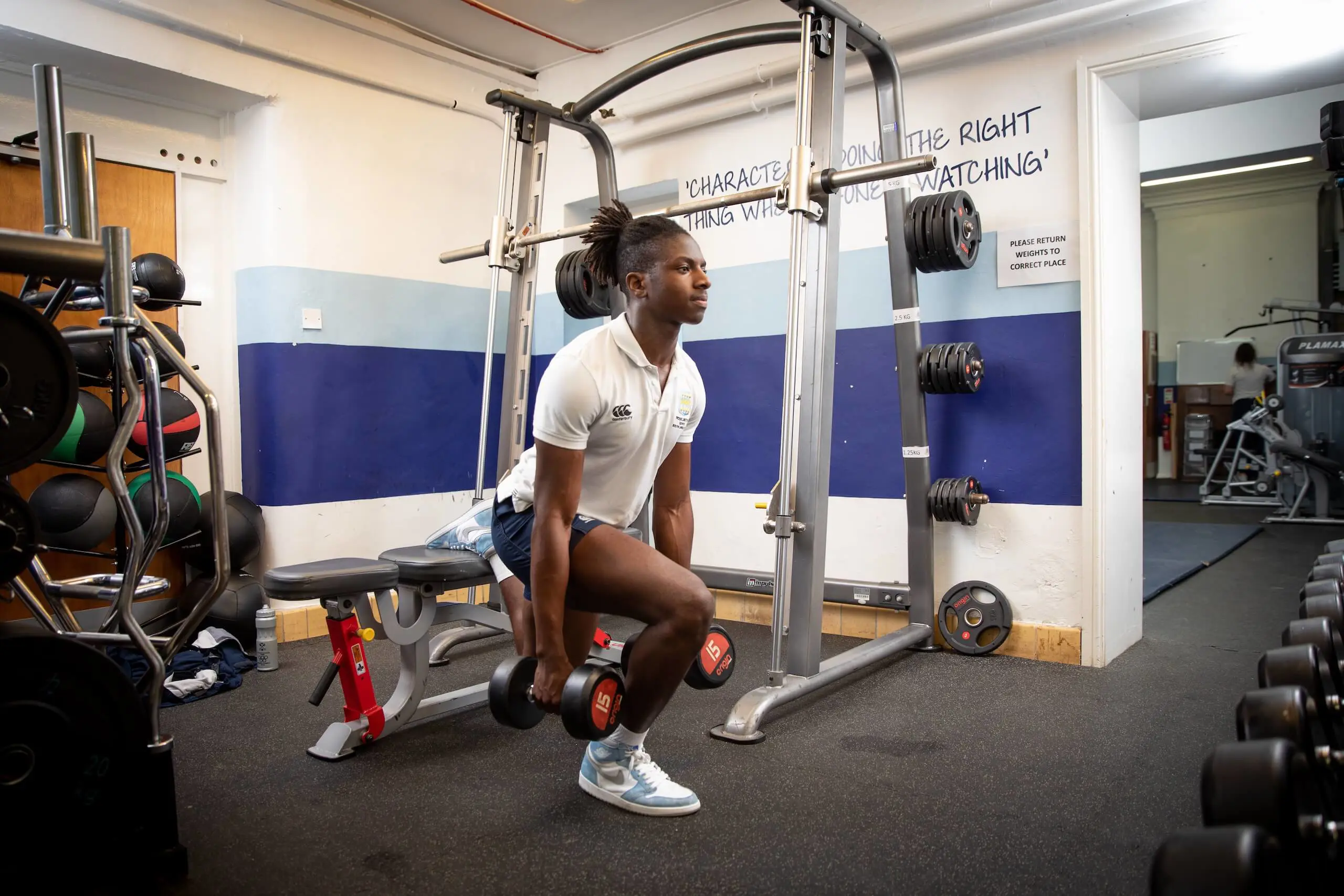 Pocklington School pupil in gymnasium squat lifting