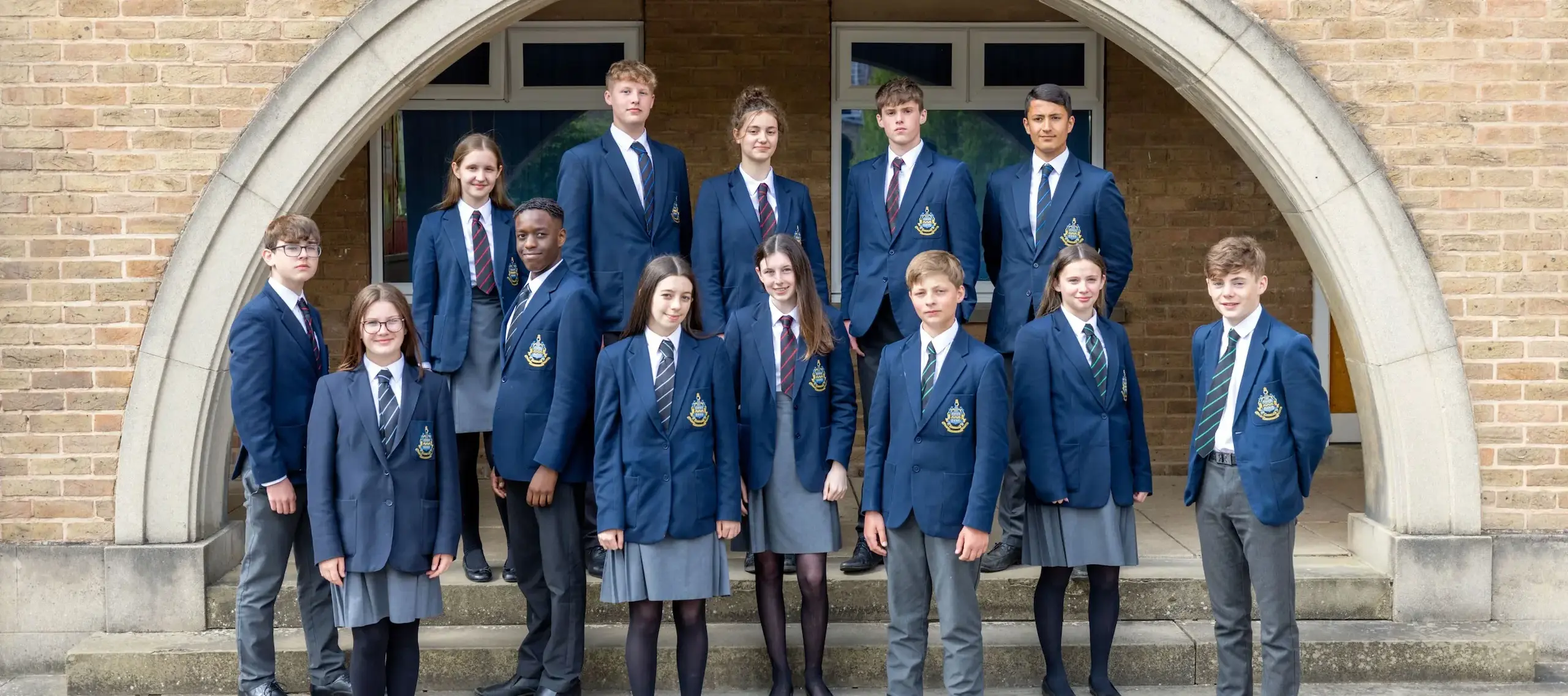 Pocklington Middle School pupils standing under arches in St Nicholas Quad