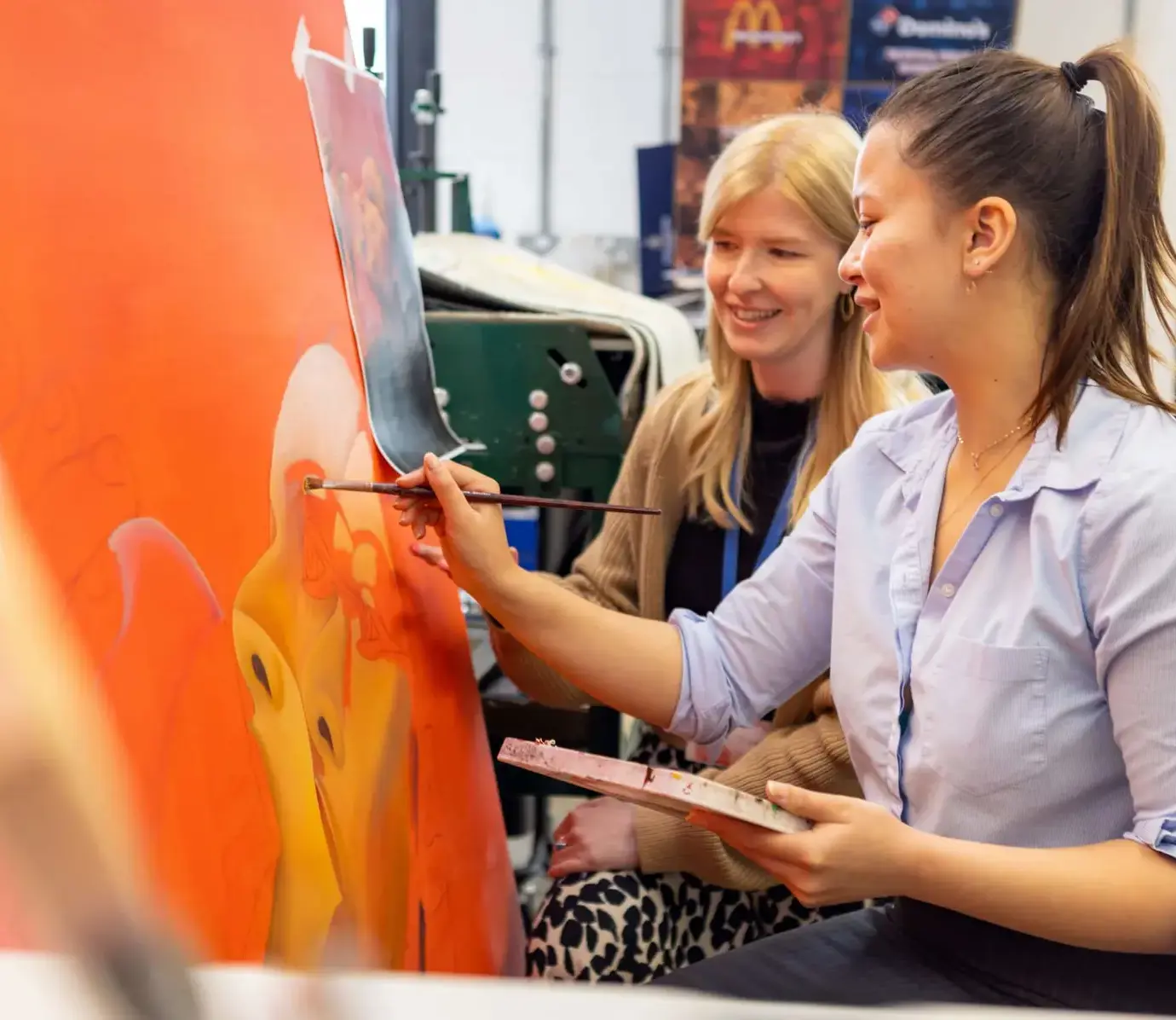 Pocklington Sixth Form student painting in art room