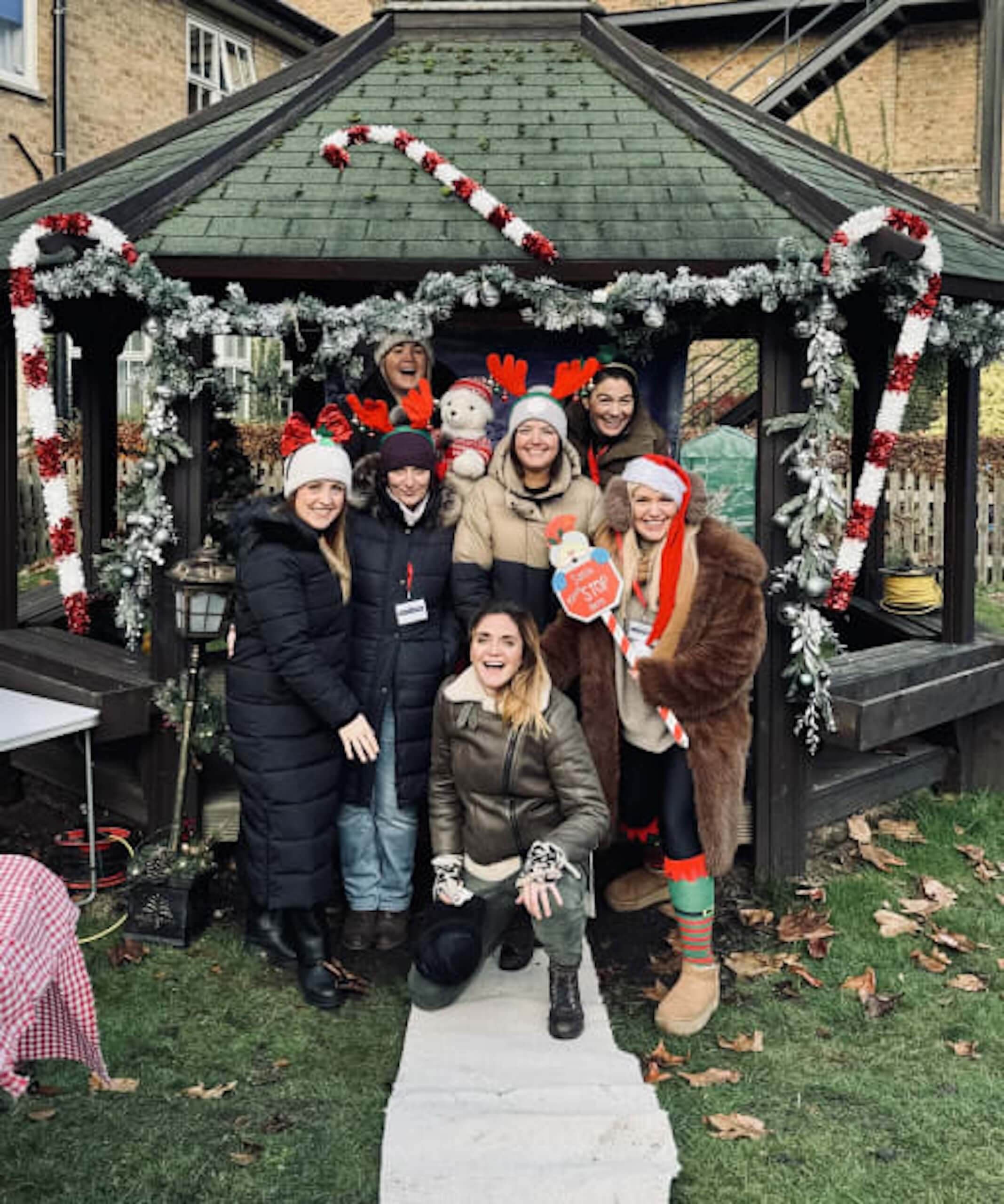 Pocklington staff smiling around christmas decorations