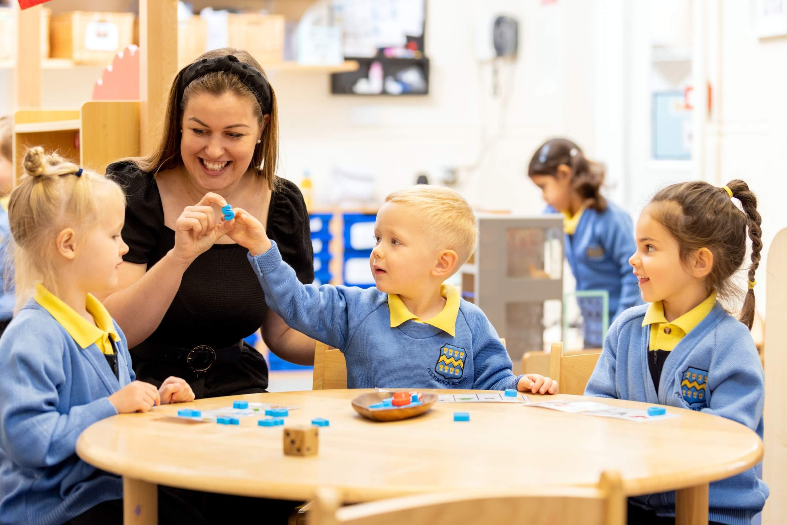 Pre-Prep pupils at school sitting around a table learning. 