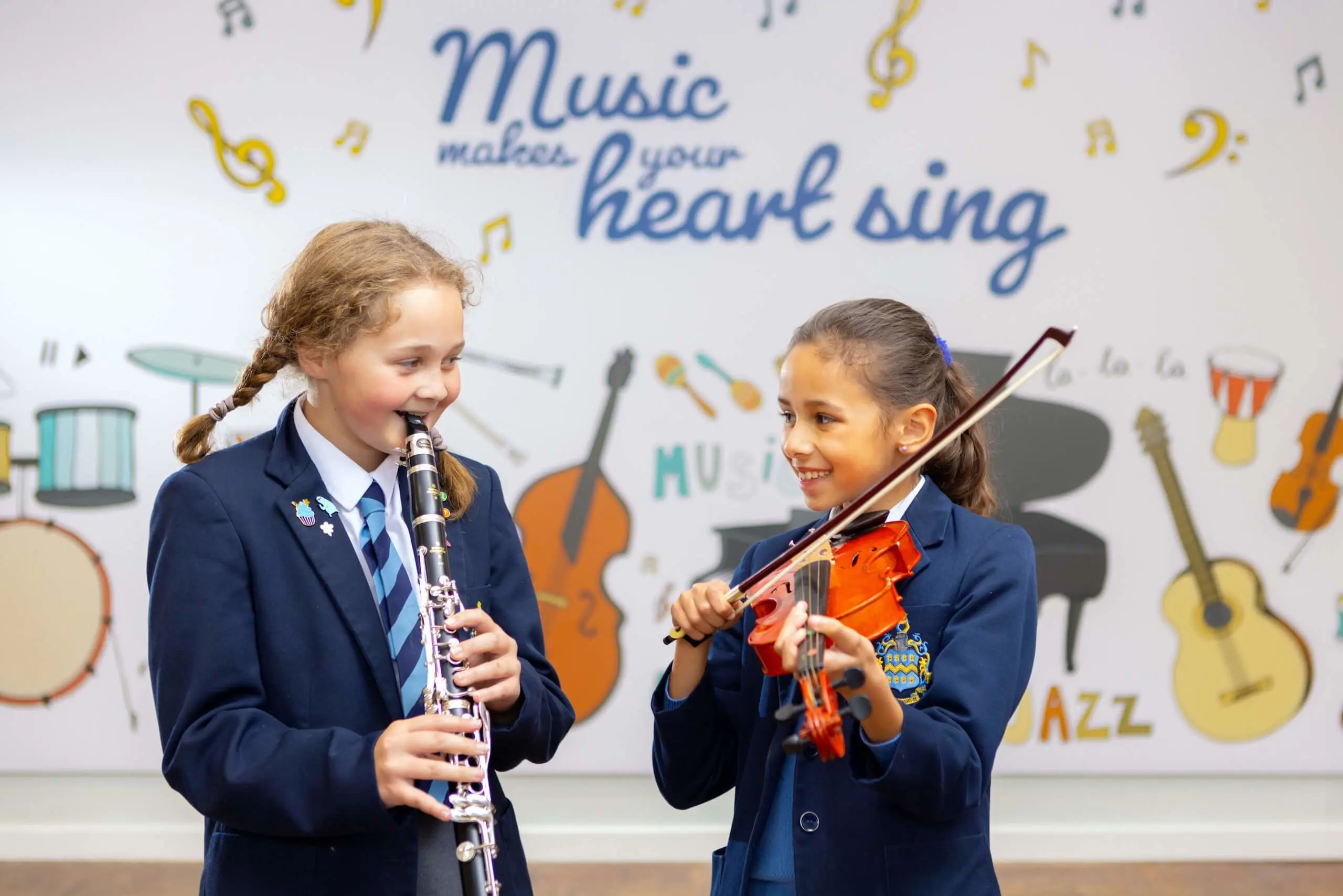 Two Prep School girls, one playing clarinet, the other playing violin.