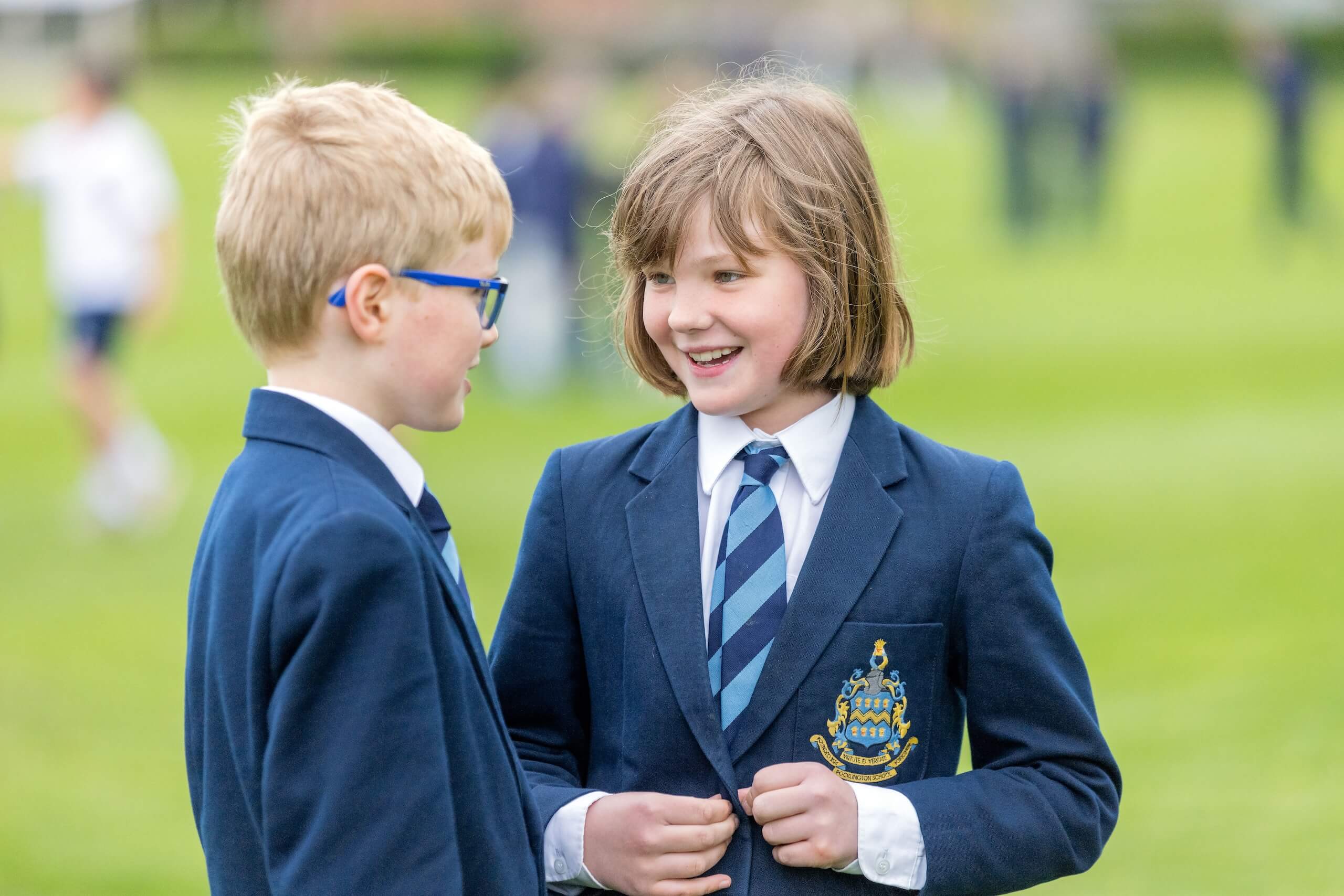 Two Pocklington Prep School pupils talking together outside. 