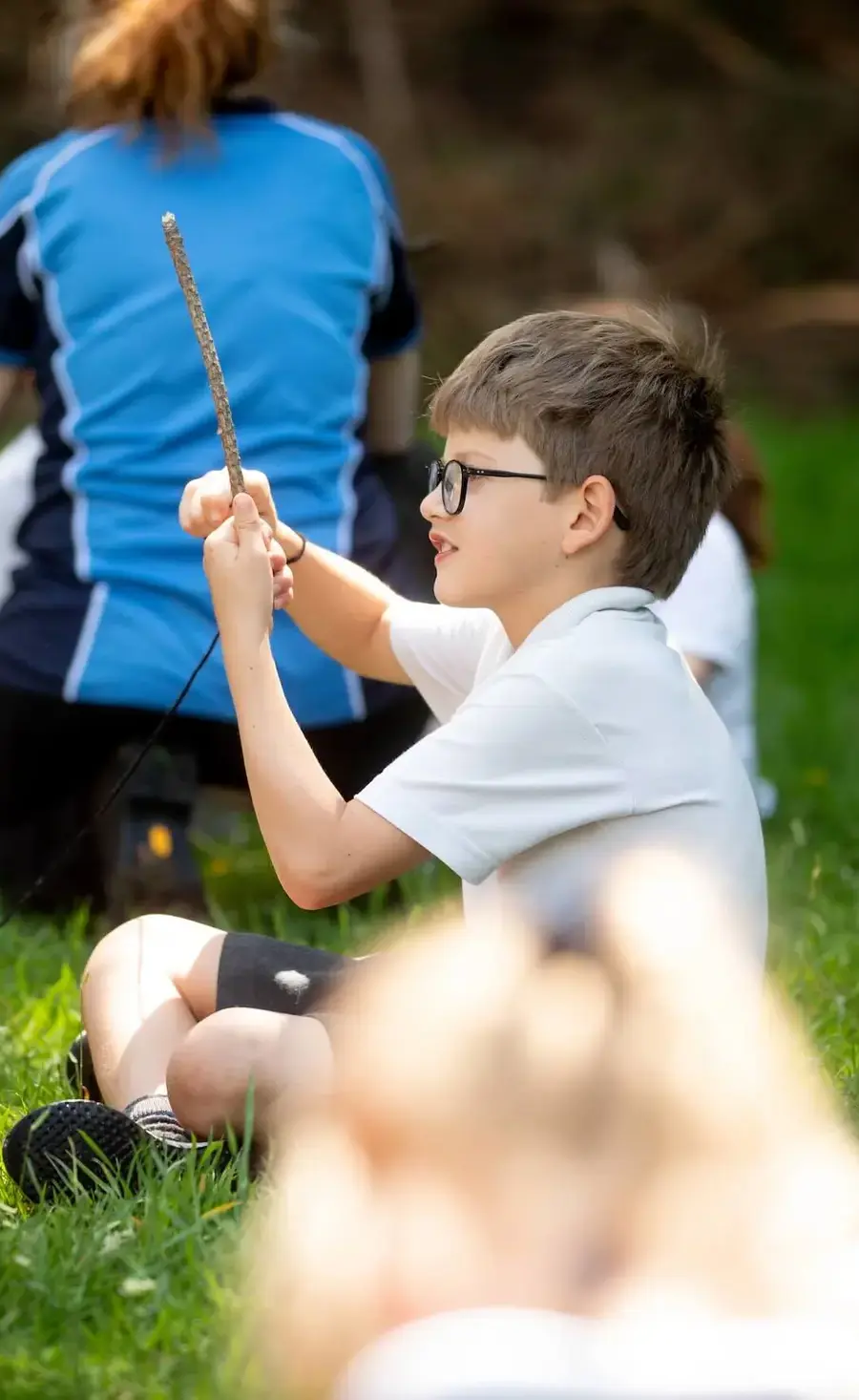 Pocklington Prep School pupil with a stick in Forest School