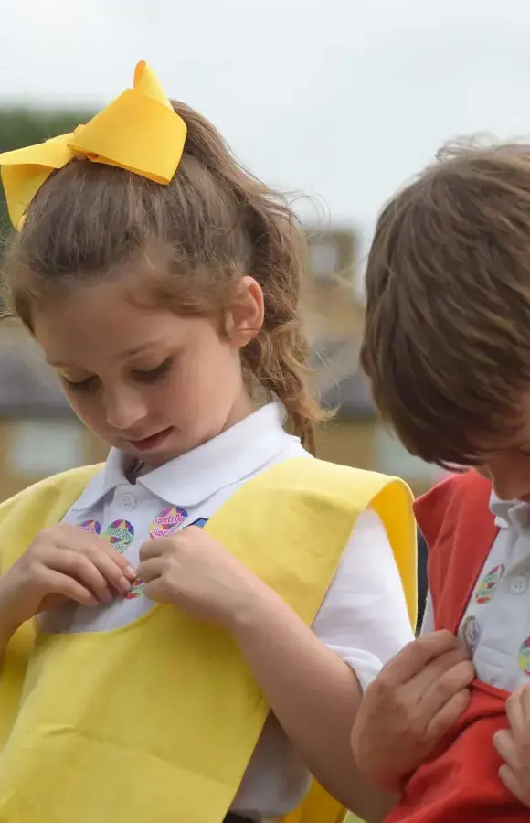 Pocklington Pre-School pupils at sports day looking pleased with stickers