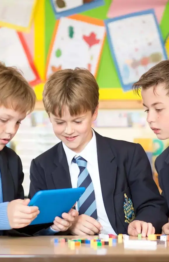 Three Pocklington Prep School pupils use an IPad to assist with a counting game