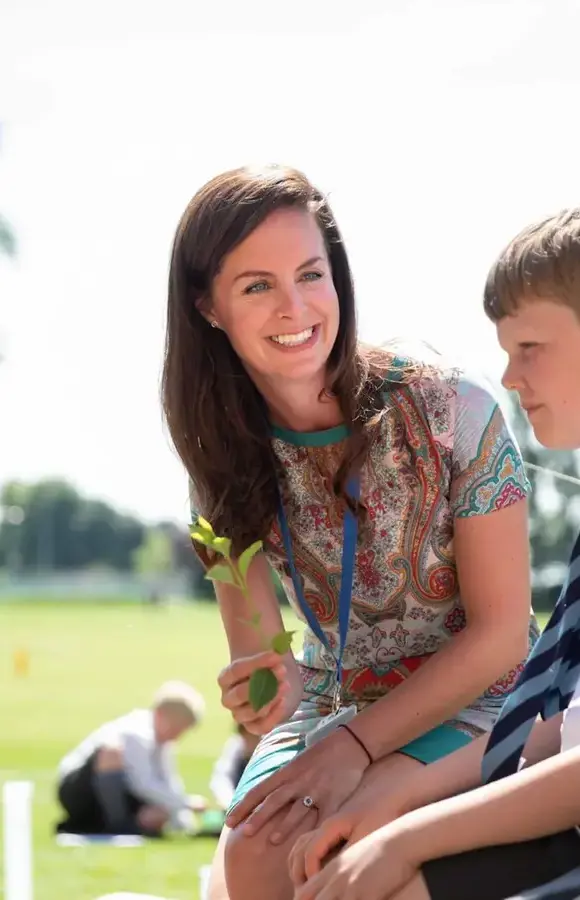 Pocklington Prep School teacher sits outside chatting with pupils