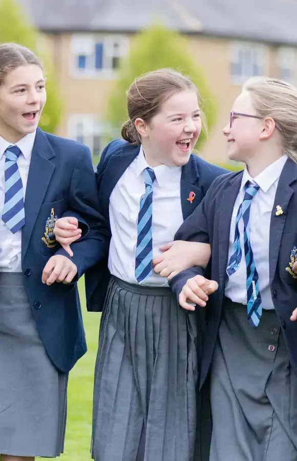 Pocklington Prep School pupils stand in a line with linked arms, smiling