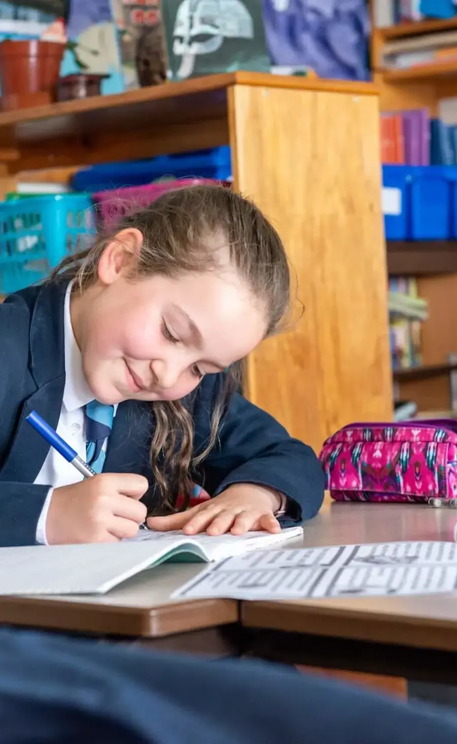 Pocklington Prep School pupil writing at a desk in a classroom 