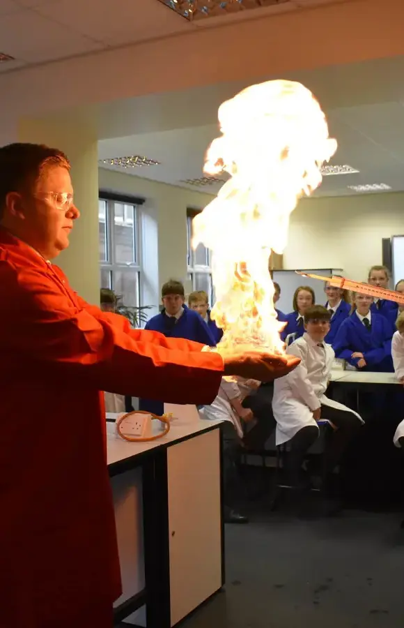 Teacher doing flaming hands experiment with Pocklington School pupils in science classroom