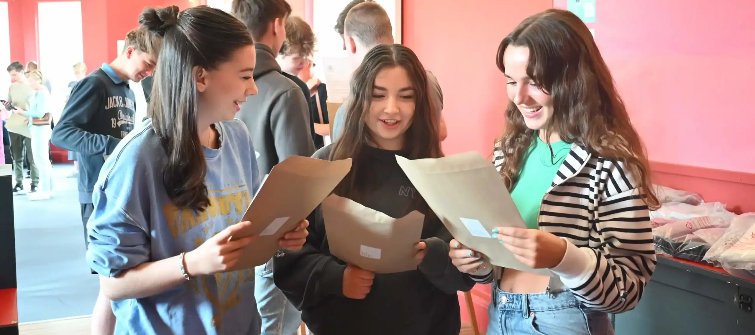 Pocklington School GCSE students with results envelopes