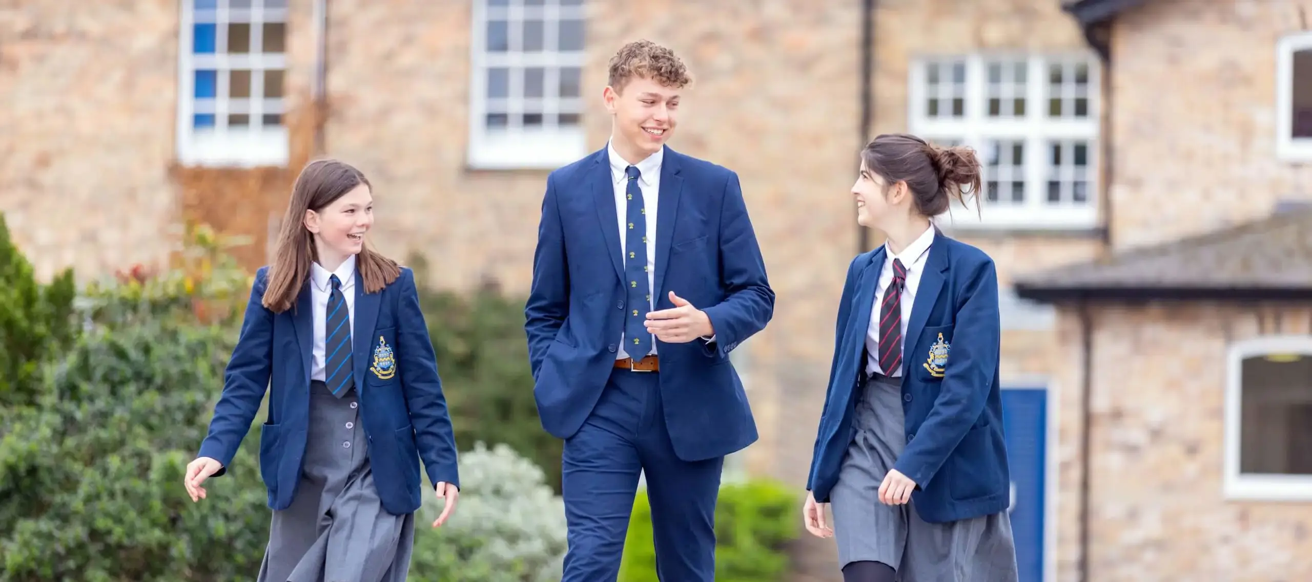 Pocklington School pupils in smart uniform walking and chatting together outside