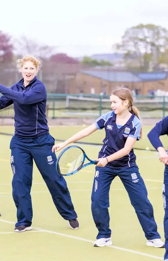 Pocklington School pupils and teacher coaching tennis