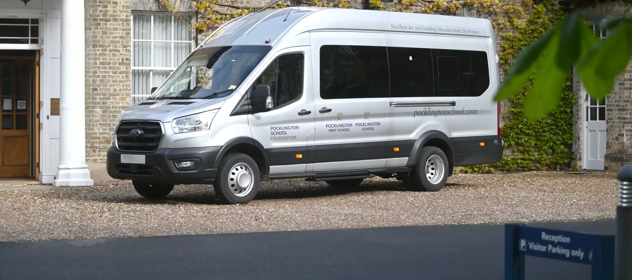 A Pocklington School minibus parked at the front of school