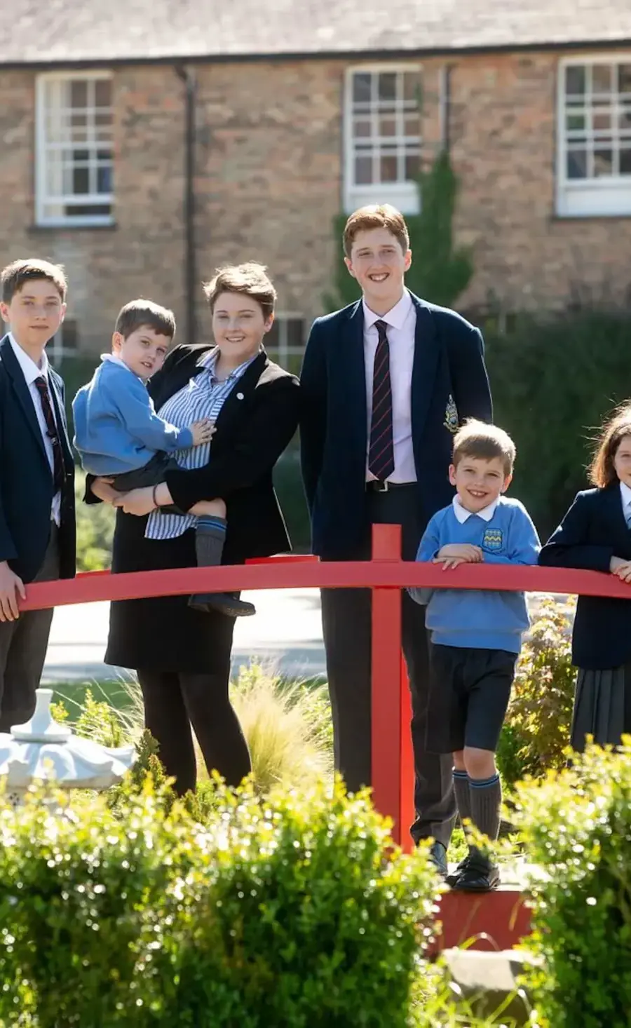 Family of Pocklington School pupils standing on the bridge outside the Art and Design 