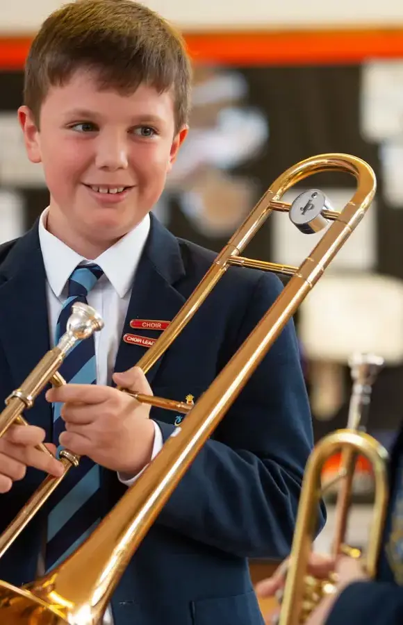 Pocklington Prep school pupil holding the trombone 