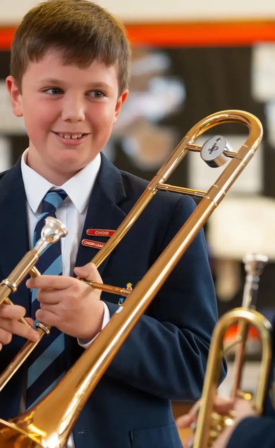 Pocklington Prep School pupils holding brass instruments and smiling