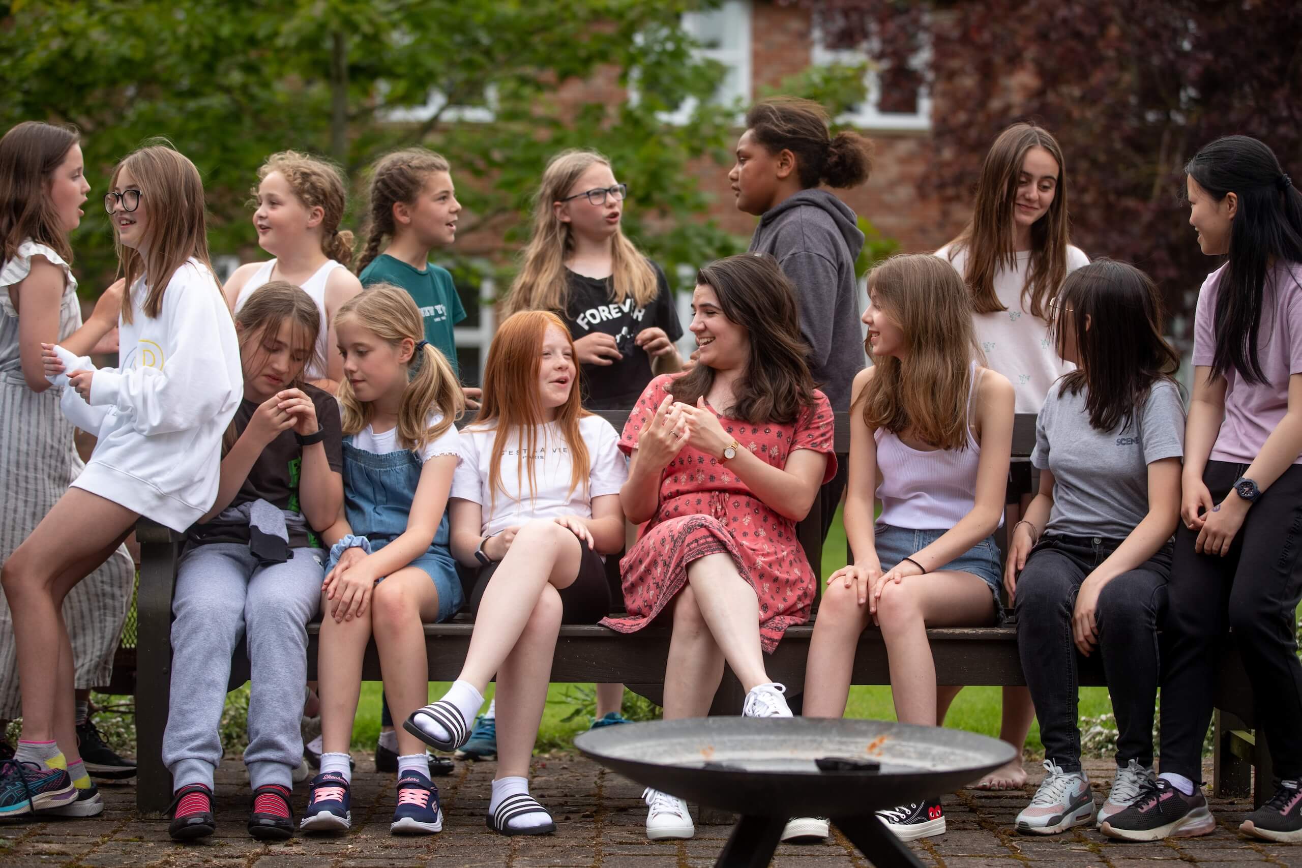 Boarders sitting on a bench outside