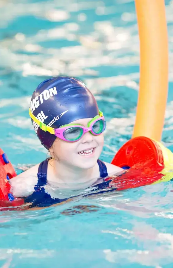 Pocklington Pre-Prep pupil in swimming pool with Pocklington School branded swim cap