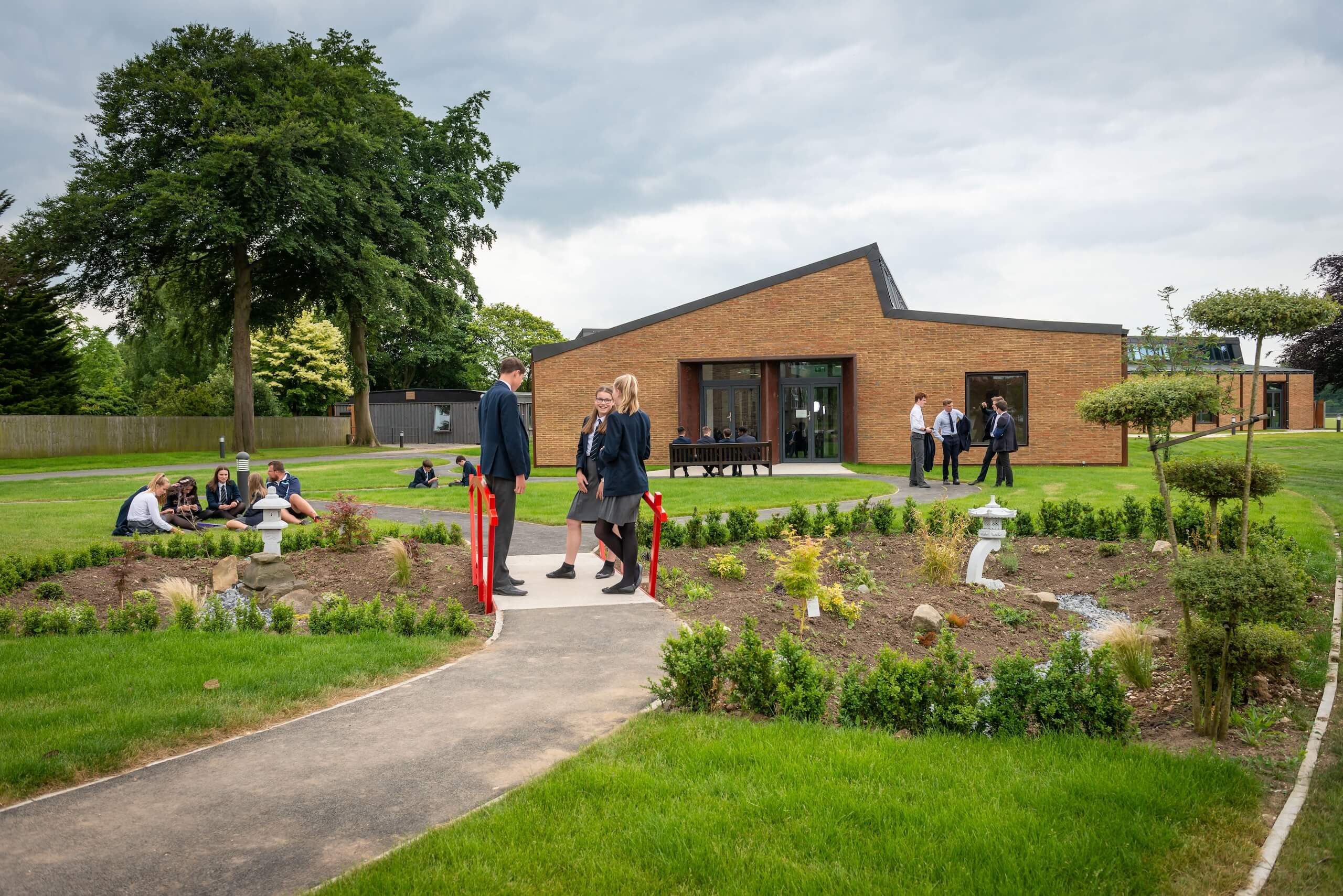 Pocklington School art and design technology centre with red bridge and Japanese garden in foreground