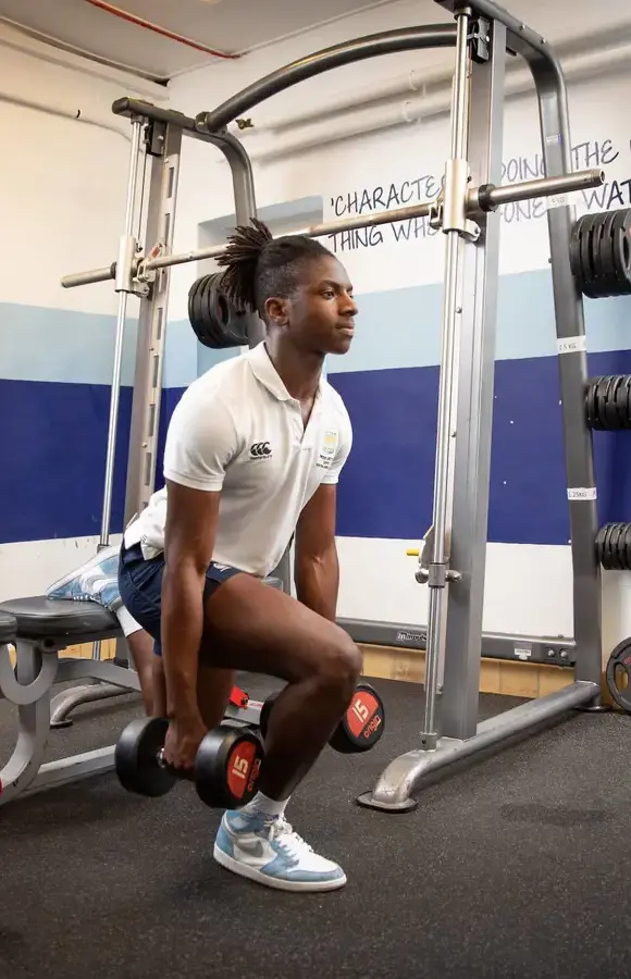 Pocklington School Sixth Former lifting weights in school gym