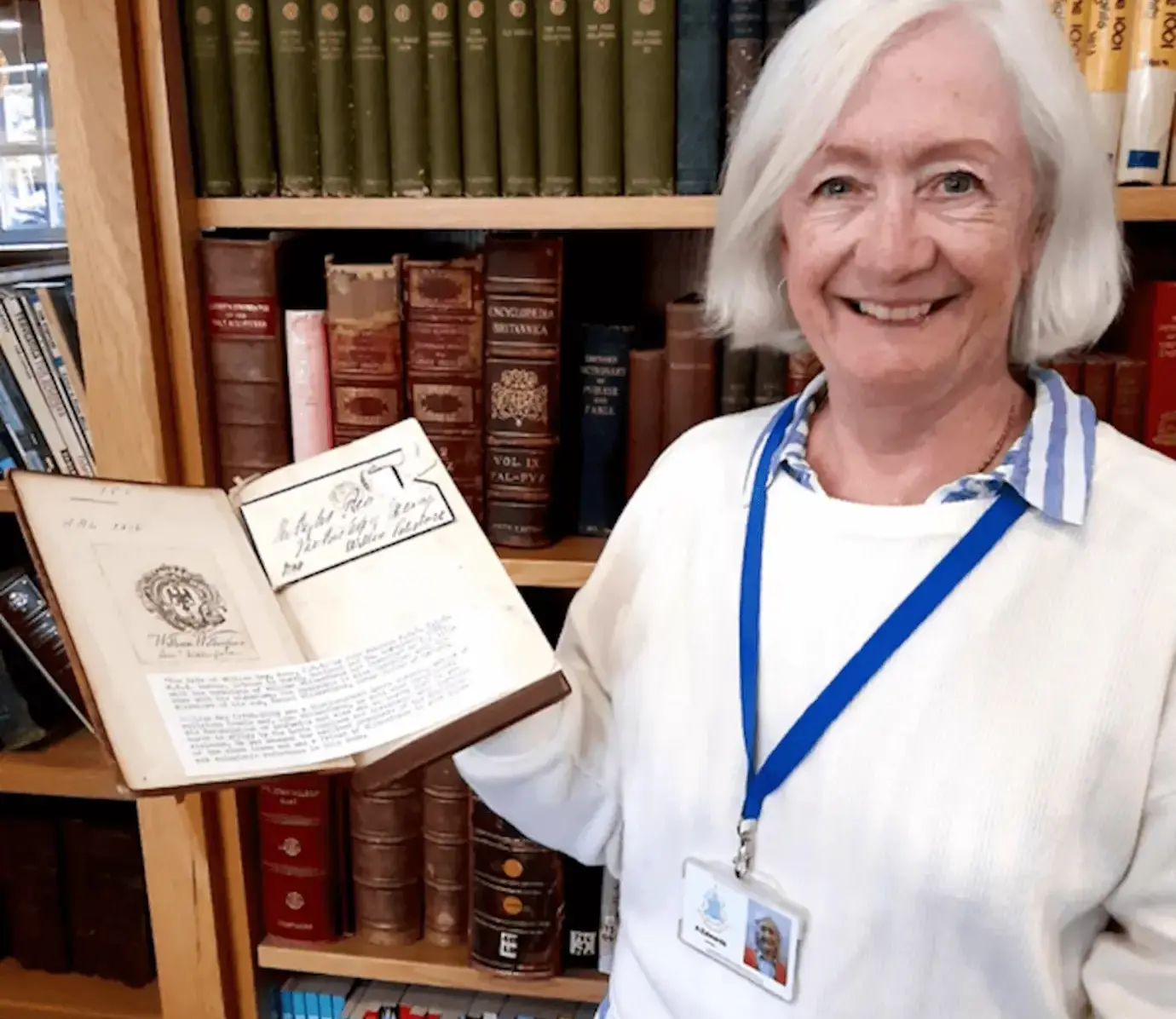 Pocklington School staff member holding a gift of a book