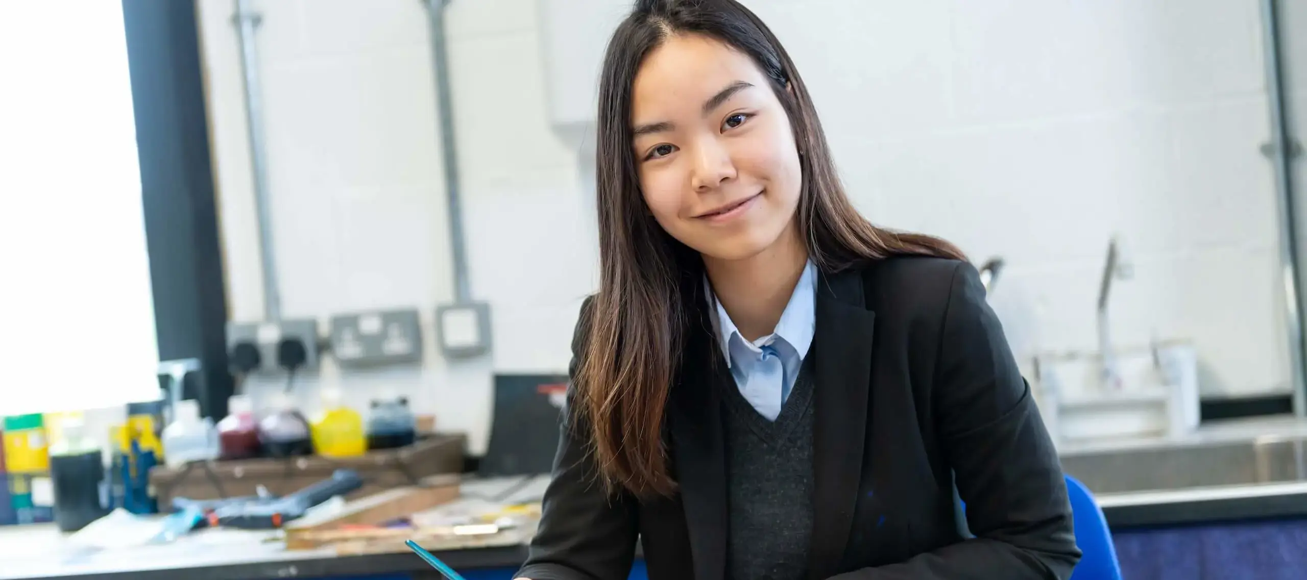 Pocklington School International Student looking at camera and holding a pencil