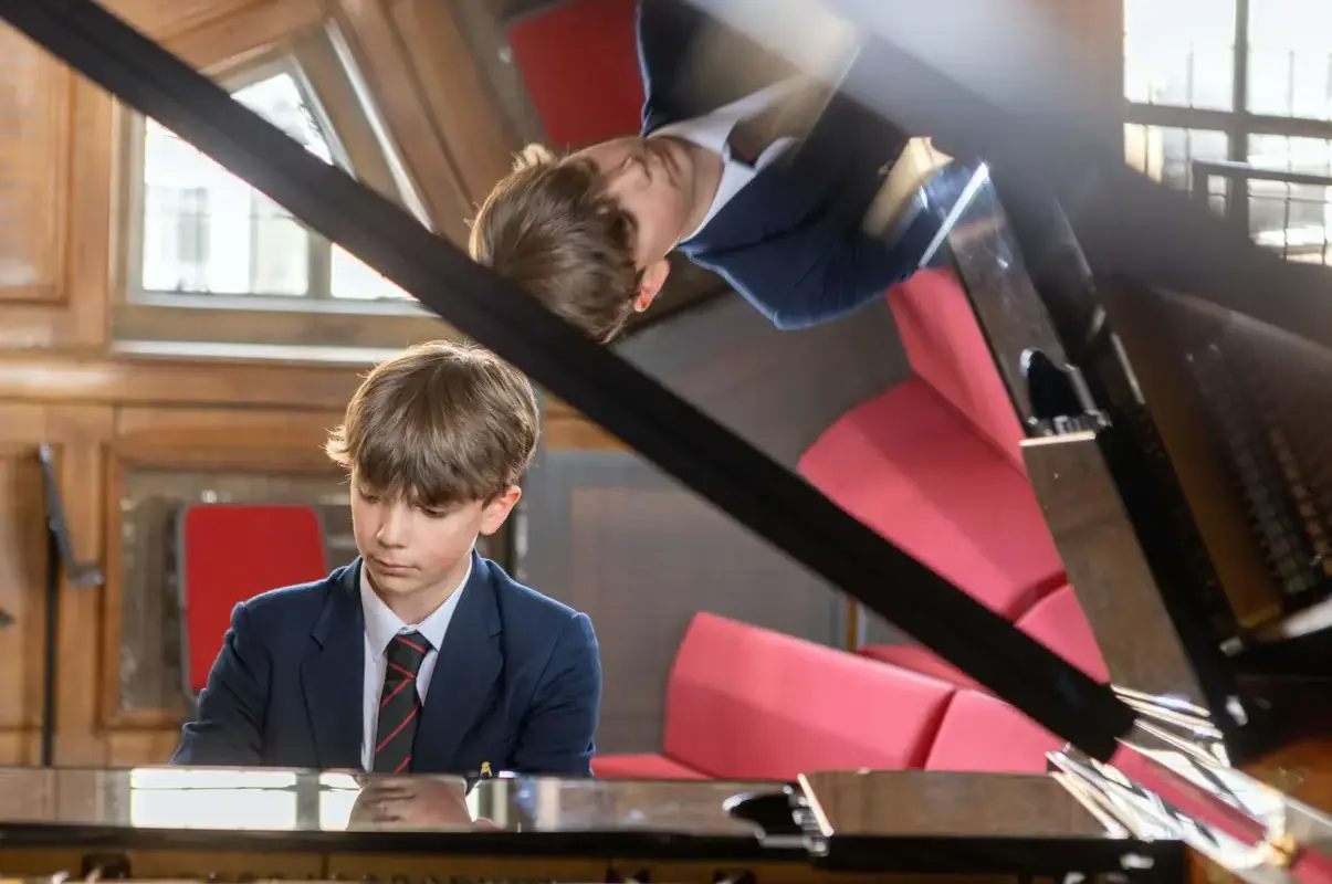 Pocklington School pupil playing piano in music school