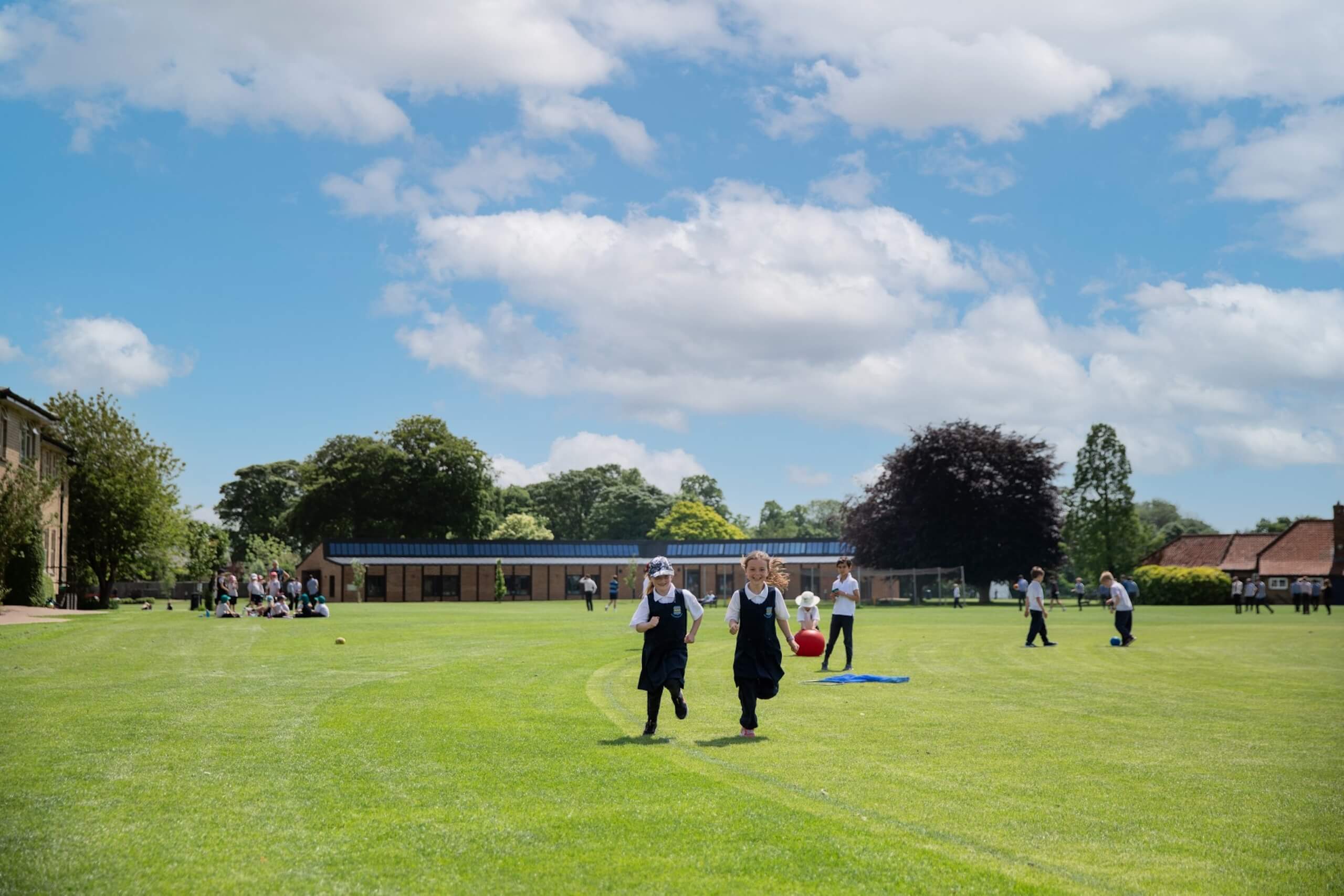 Young children running outside on the Pocklington School grounds