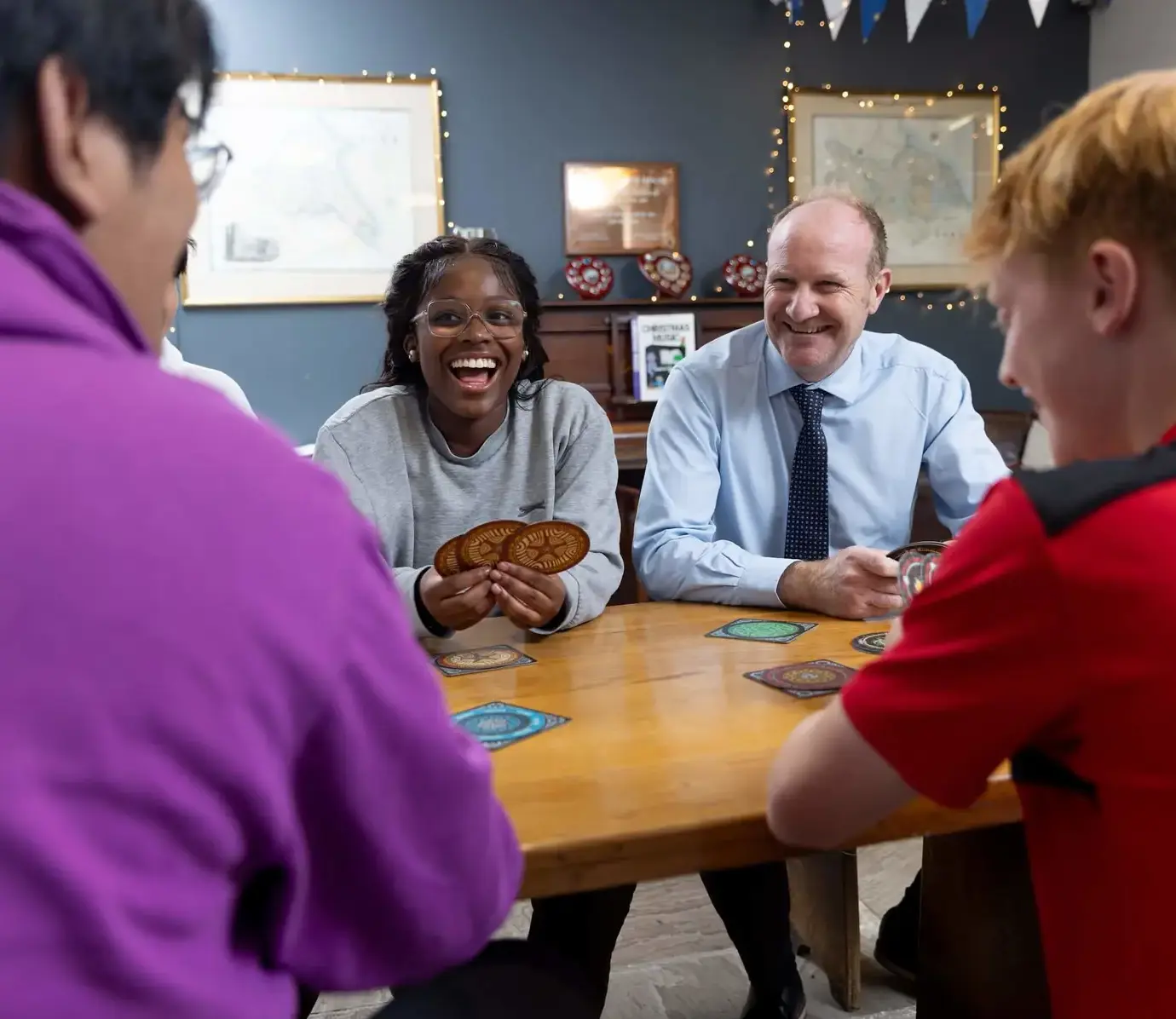 Pocklington School boy and girl boarders with the head of boarding playing card games