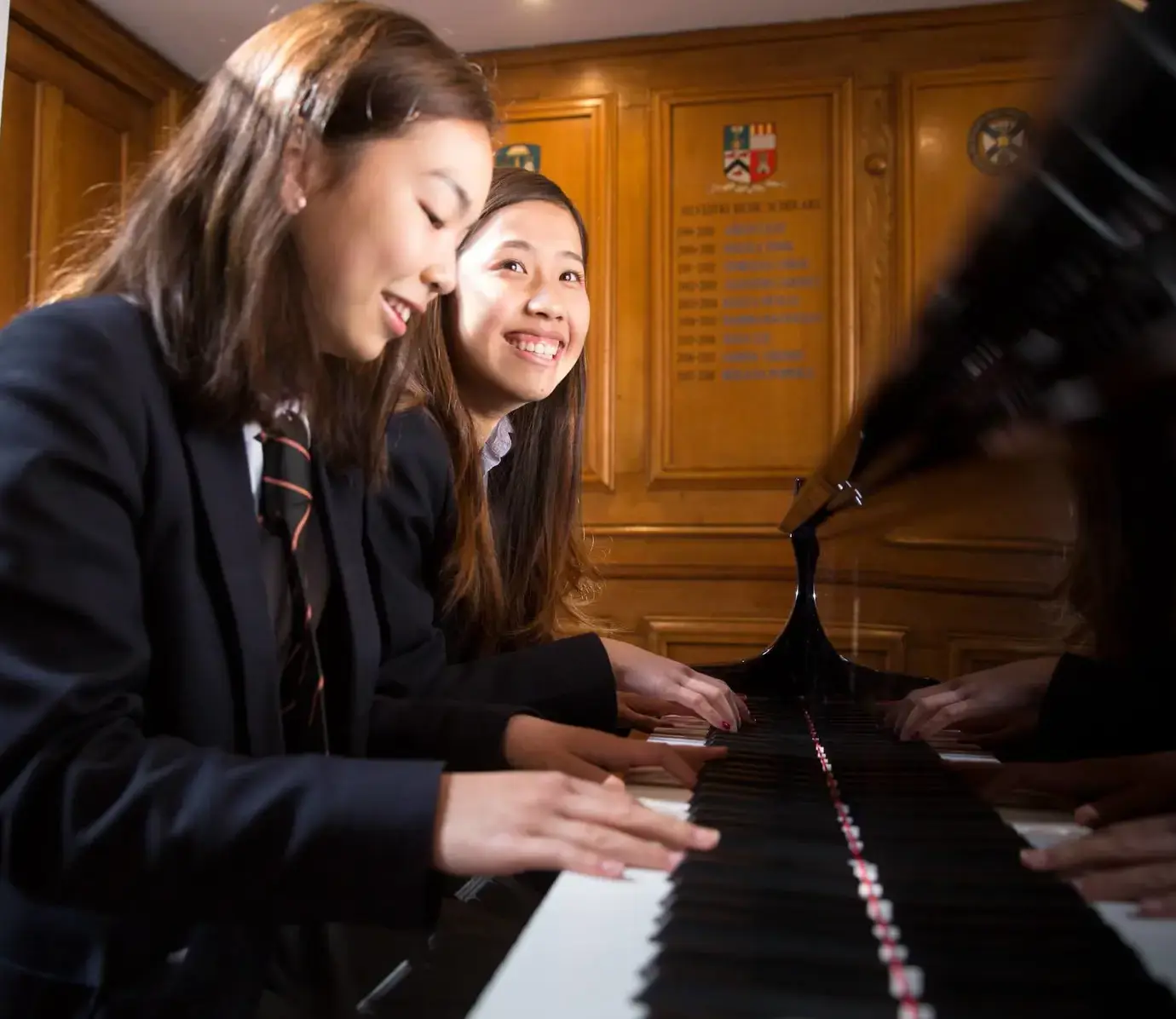 Two Pocklington School International students playing piano together