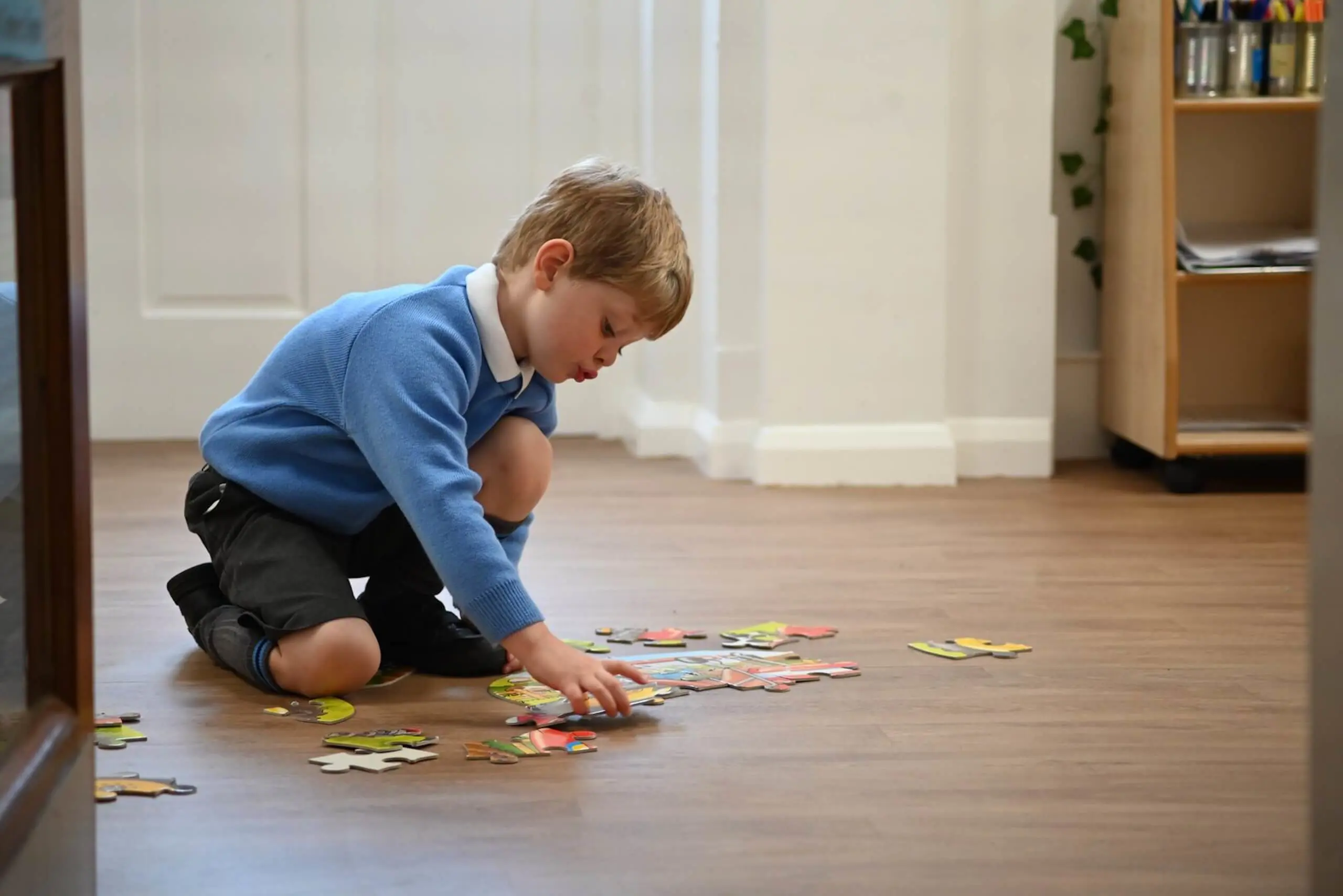 Pocklington Pre-School pupil playing with a jigsaw in the Pre-School classroom. 