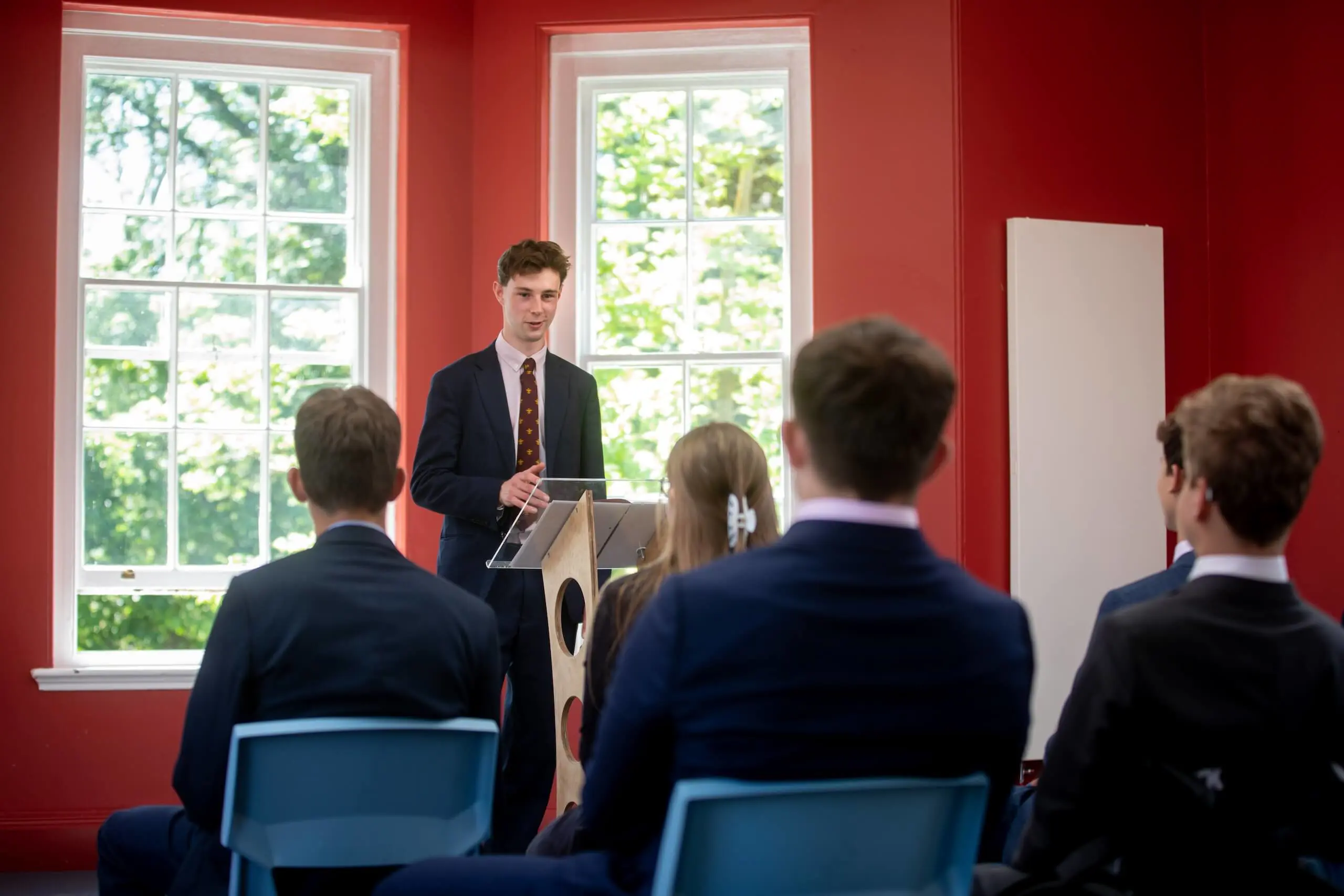 Pocklington School Sixth Former at a podium speaking to an audience