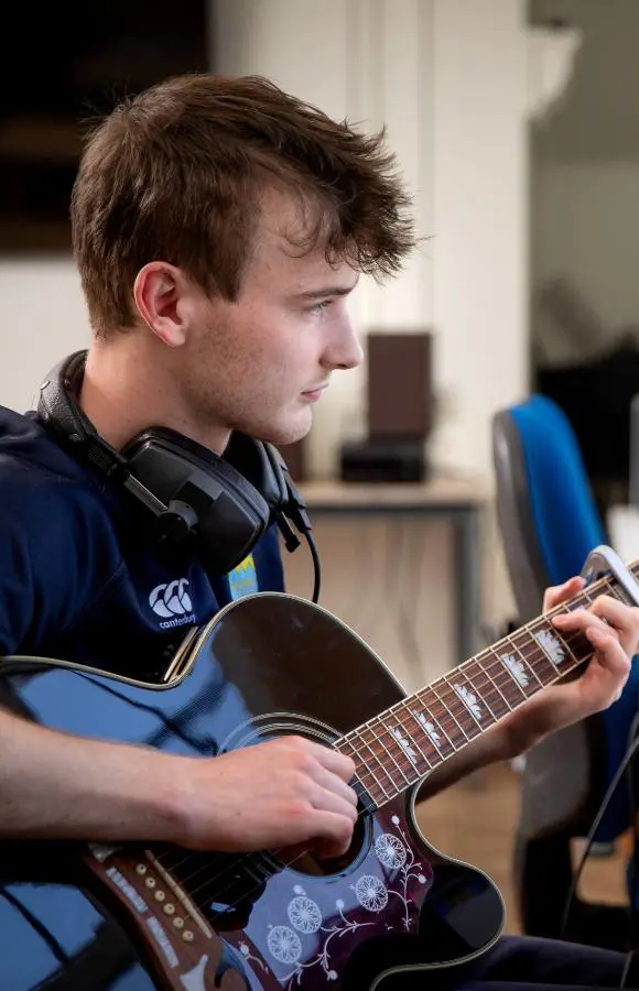 Pocklington School pupil learning electric guitar