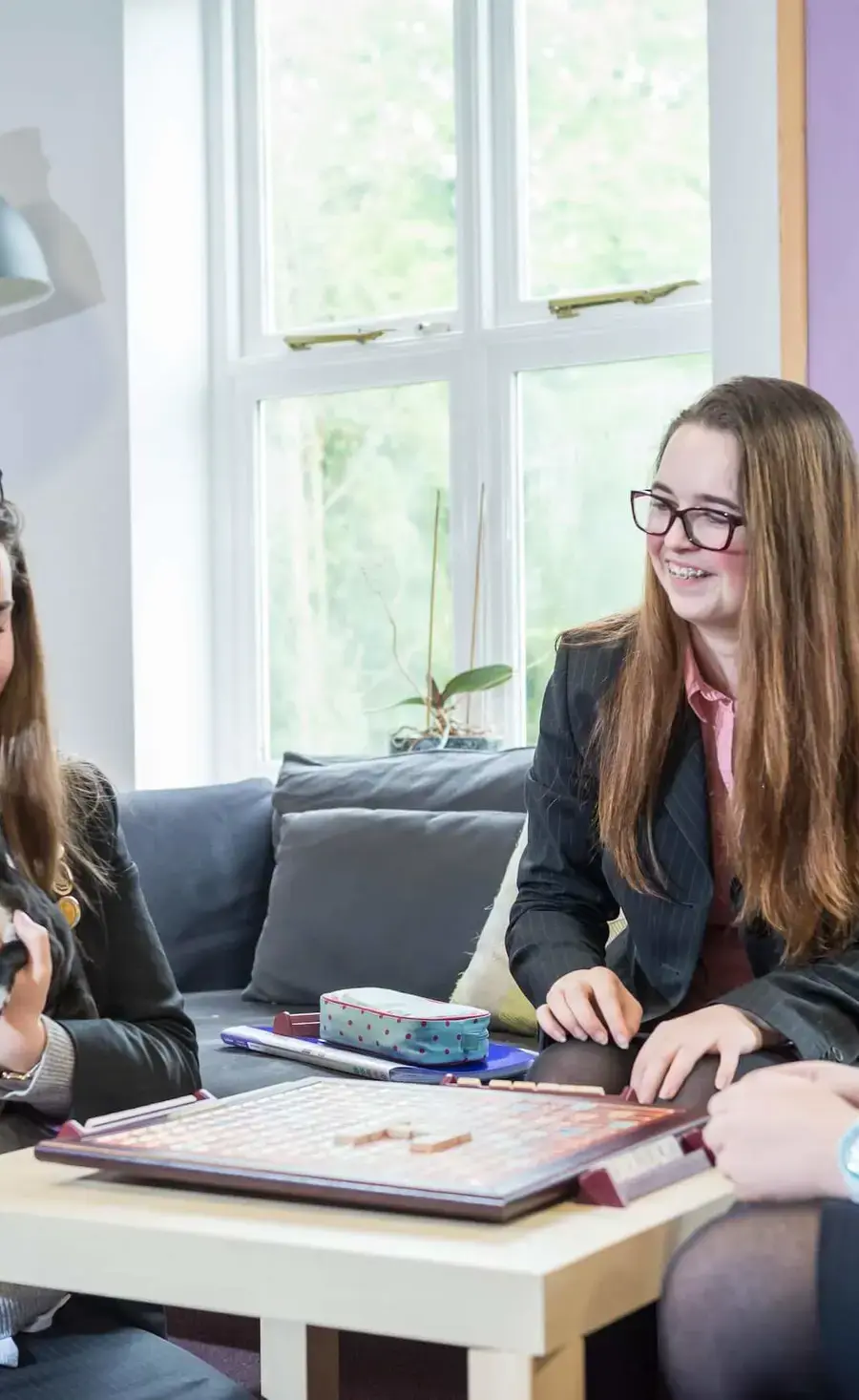 Boarding pupils playing games and holding a dog