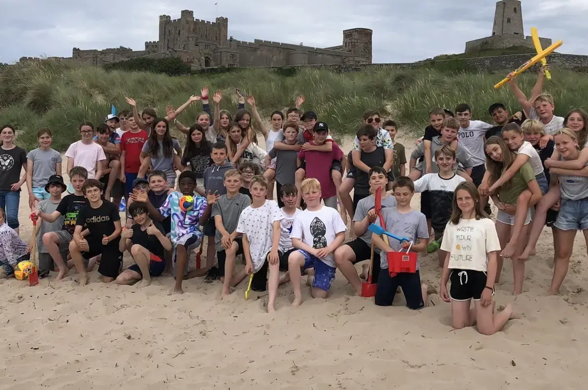 Group picture of Lower School House Camp on the beach