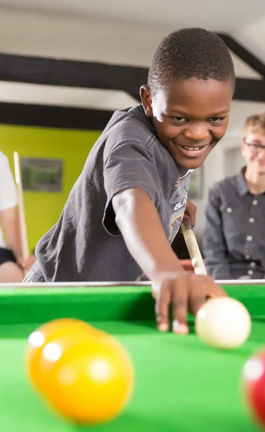 Boarding pupil playing pool