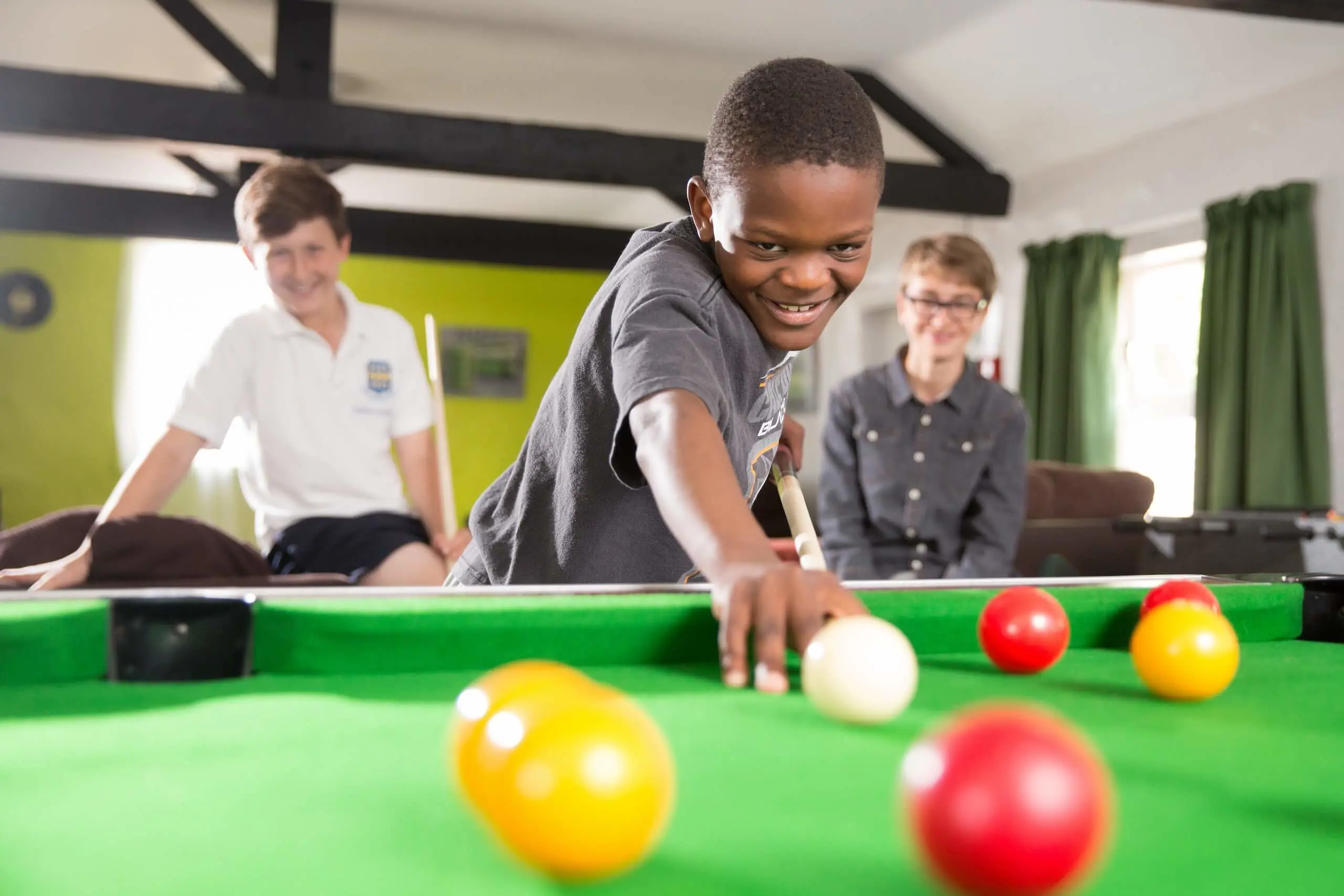 Junior boarder playing pool