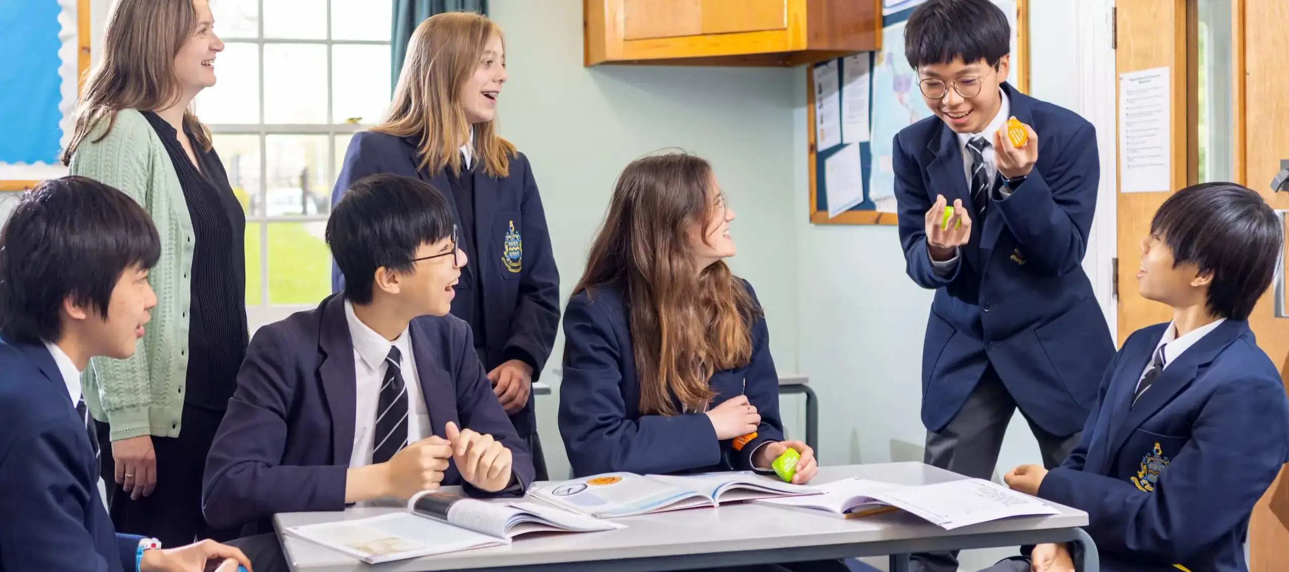 International students at Pocklington School in classroom playing a juggling game